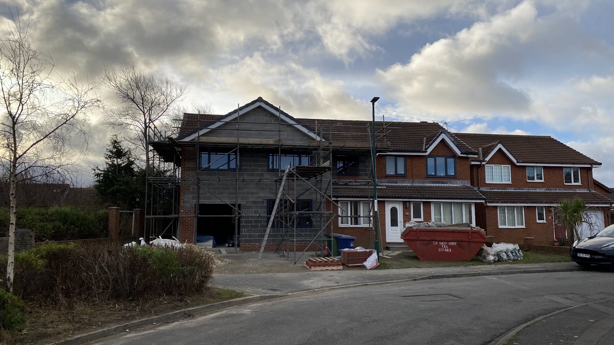 The two-storey side extension at full height in blockwork with a pitched roof on and new windows fitted