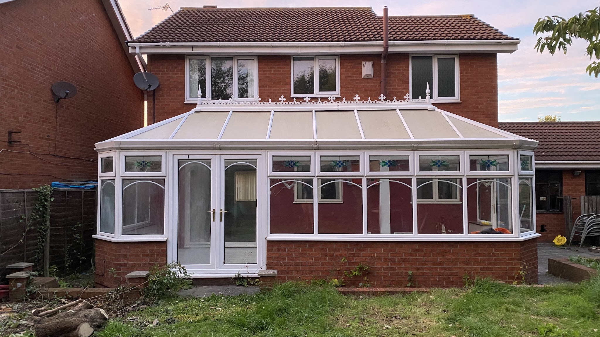 The rear of the house before work, with an old white uPVC conservatory